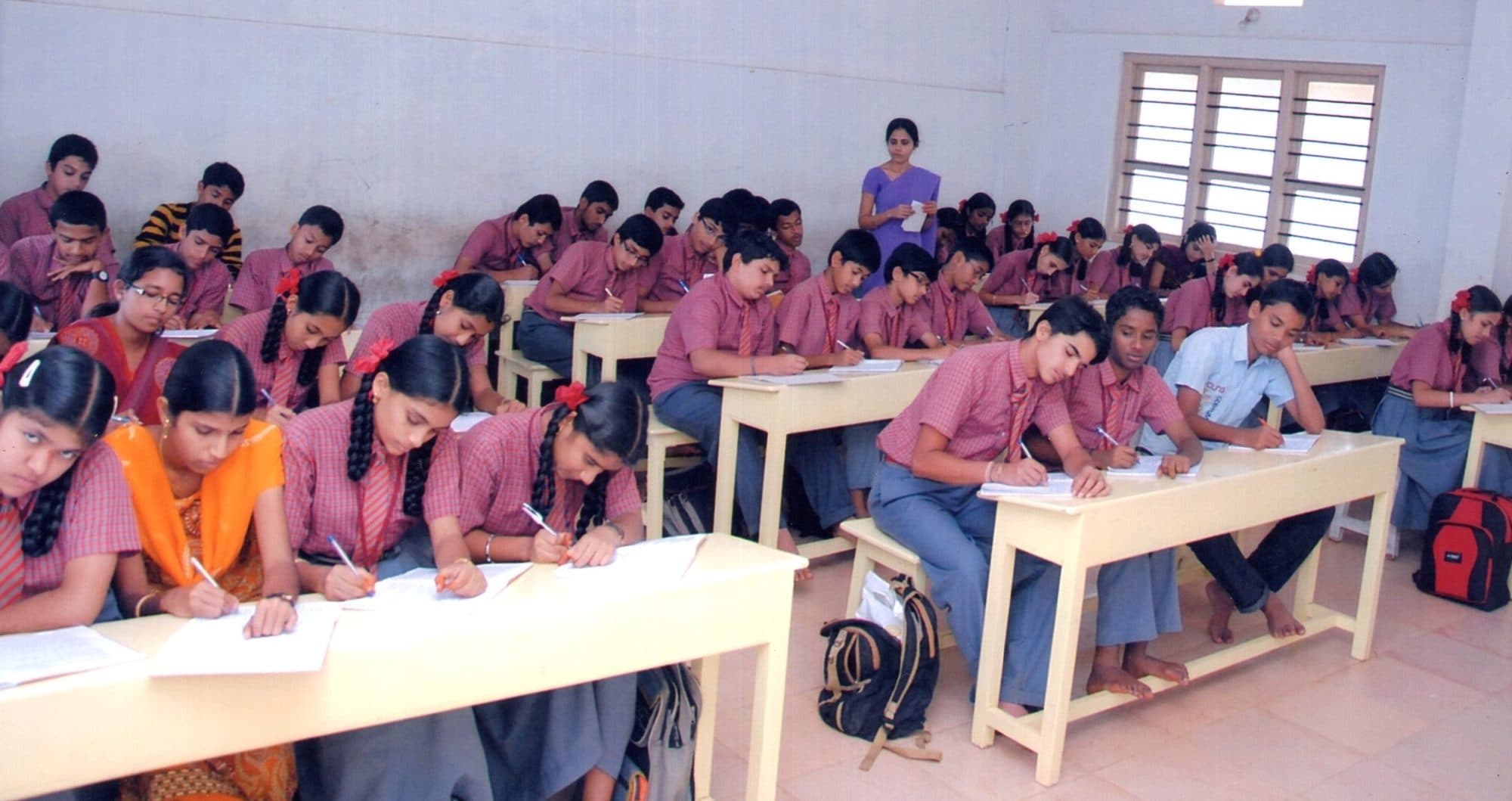 High-school students writing an examination